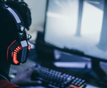 man playing games wearing headphone