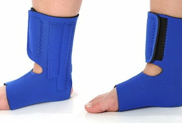 Foot with an ankle brace, over white