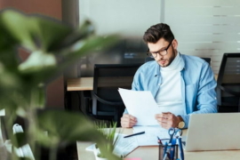 worker looking at documents at office
