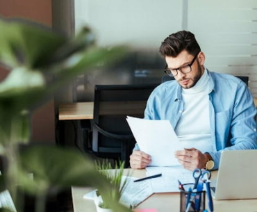 worker looking at documents at office