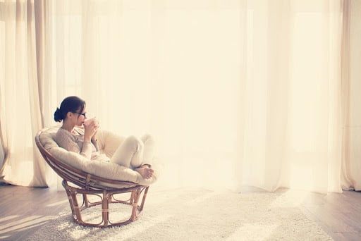 lady relaxing in living room with tea