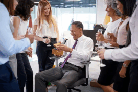 man receiving gifts in office