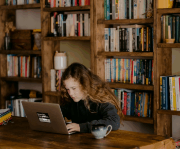girl using laptop in library