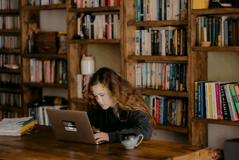 girl using laptop in library